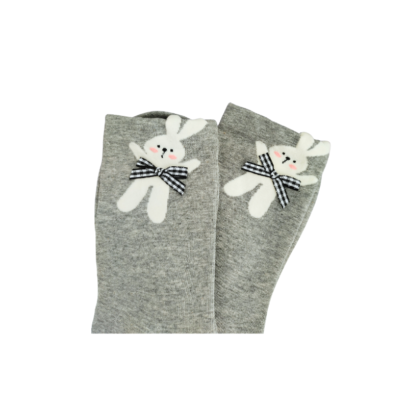 Grey knit crew socks with a plush white bunny near the cuff, featuring pink cheeks, embroidered eyes, and a black‑and‑white checkered bow.