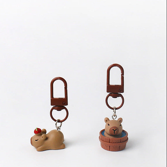 Set of three handmade capybara keychains with minimalist brown designs and matching brown clasps
