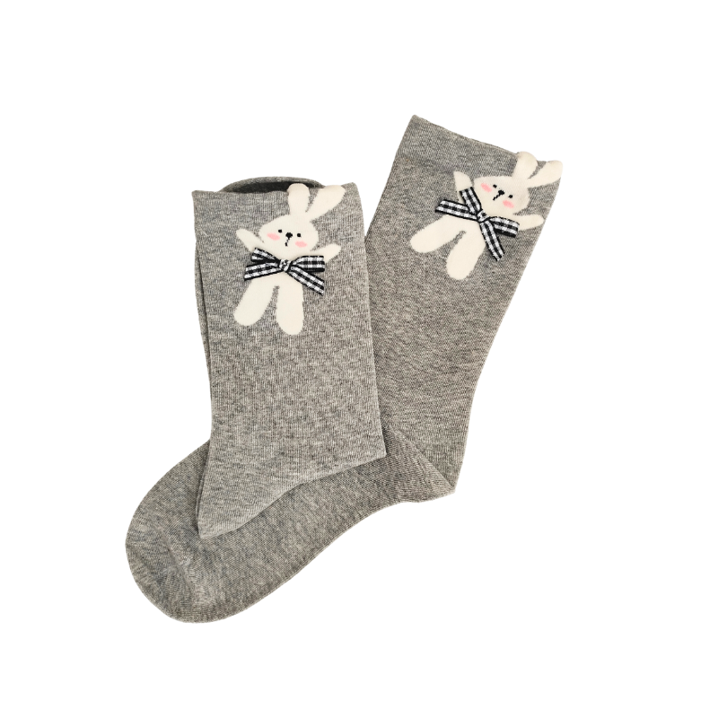 Grey knit crew socks with a plush white bunny near the cuff, featuring pink cheeks, embroidered eyes, and a black‑and‑white checkered bow.