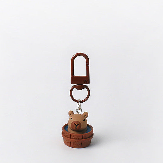Set of three handmade capybara keychains with minimalist brown designs and matching brown clasps