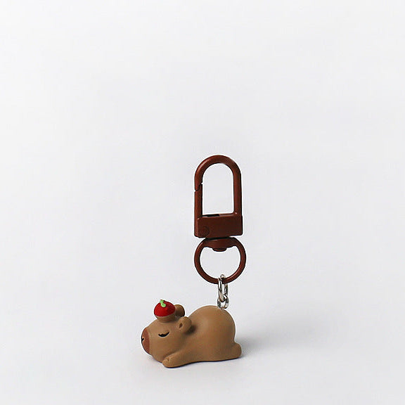 Set of three handmade capybara keychains with minimalist brown designs and matching brown clasps