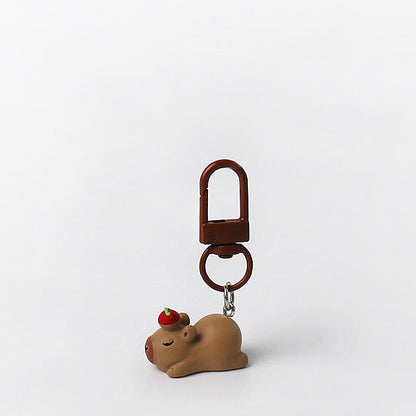 Set of three handmade capybara keychains with minimalist brown designs and matching brown clasps