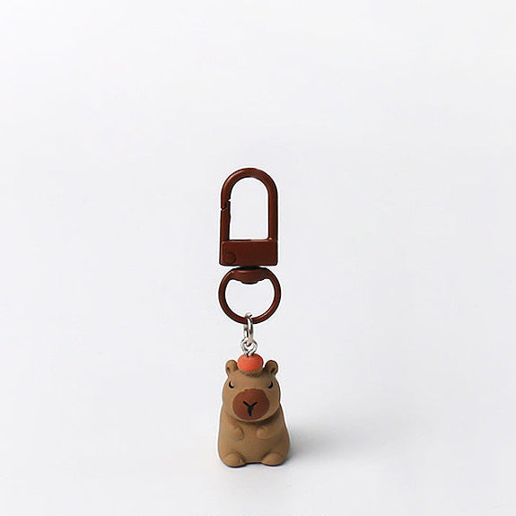 Set of three handmade capybara keychains with minimalist brown designs and matching brown clasps