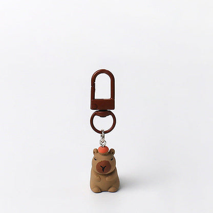 Set of three handmade capybara keychains with minimalist brown designs and matching brown clasps