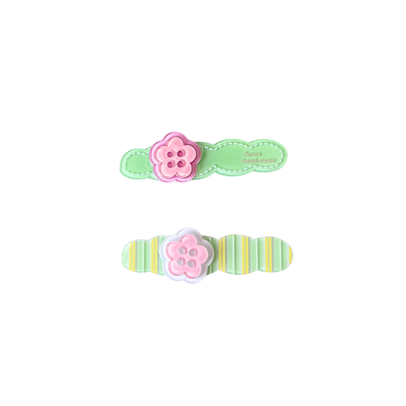 A playful 2‑piece flower‑button hair clip set featuring pastel bases and pink flower buttons — perfect for soft‑girl, kawaii, and everyday cute hairstyles.
