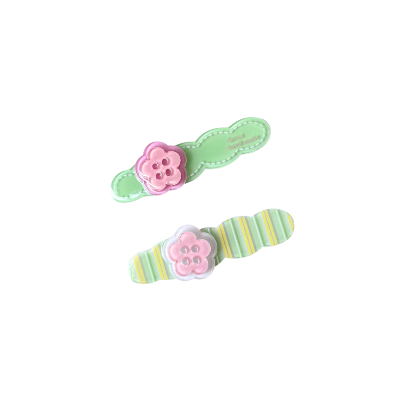 A playful 2‑piece flower‑button hair clip set featuring pastel bases and pink flower buttons — perfect for soft‑girl, kawaii, and everyday cute hairstyles.