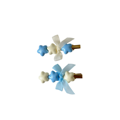 A dreamy pastel hair clip duo featuring blue and white star accents with matching ribbon bows — perfect for soft‑girl, kawaii, and everyday cute hairstyles.