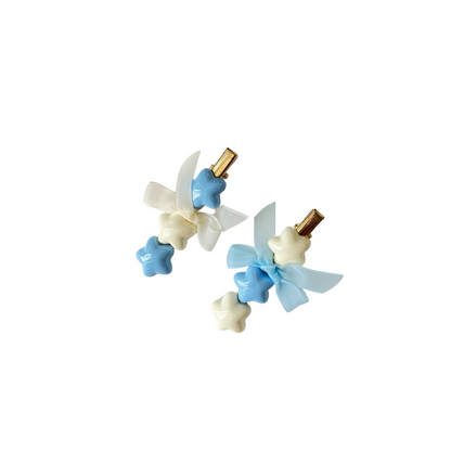 A dreamy pastel hair clip duo featuring blue and white star accents with matching ribbon bows — perfect for soft‑girl, kawaii, and everyday cute hairstyles.