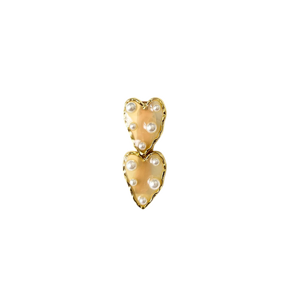 A dreamy double‑heart hair clip with glossy colour, gold trim, and delicate pearl accents — available in two sweet colour options.