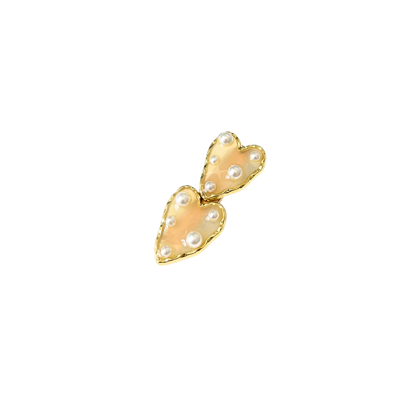 A dreamy double‑heart hair clip with glossy colour, gold trim, and delicate pearl accents — available in two sweet colour options.