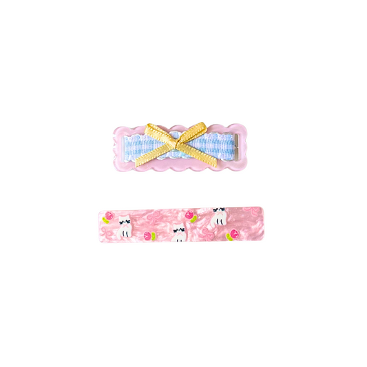 A sweet 2‑piece pink hair clip set featuring a scalloped gingham bow clip and a kitty‑floral barrette — perfect for soft‑girl, kawaii, and everyday cute hairstyles.
