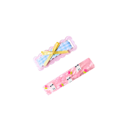 A sweet 2‑piece pink hair clip set featuring a scalloped gingham bow clip and a kitty‑floral barrette — perfect for soft‑girl, kawaii, and everyday cute hairstyles.