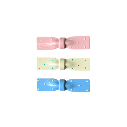 A dreamy 3‑piece set of glossy polka‑dot bow hair clips in pink, cream, and blue — the perfect soft‑girl accessory trio for everyday cuteness.