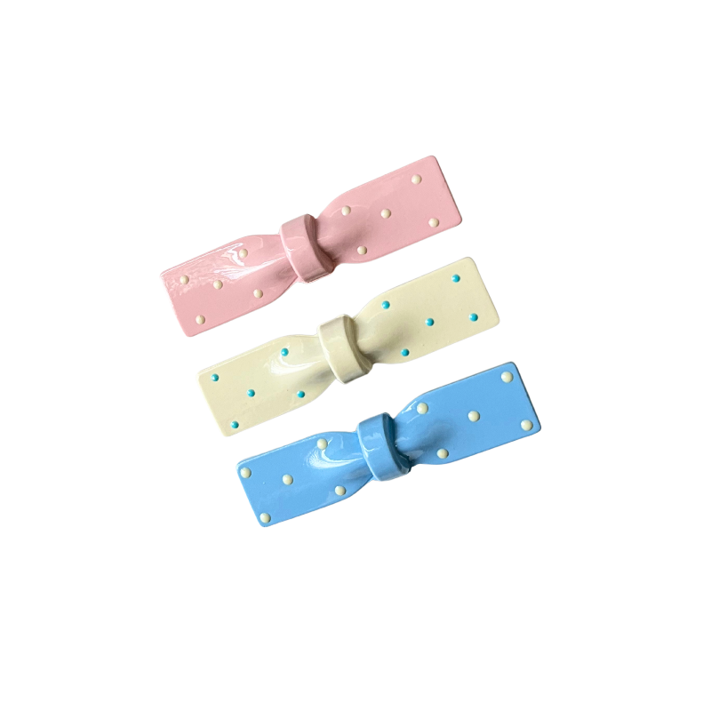 A dreamy 3‑piece set of glossy polka‑dot bow hair clips in pink, cream, and blue — the perfect soft‑girl accessory trio for everyday cuteness.