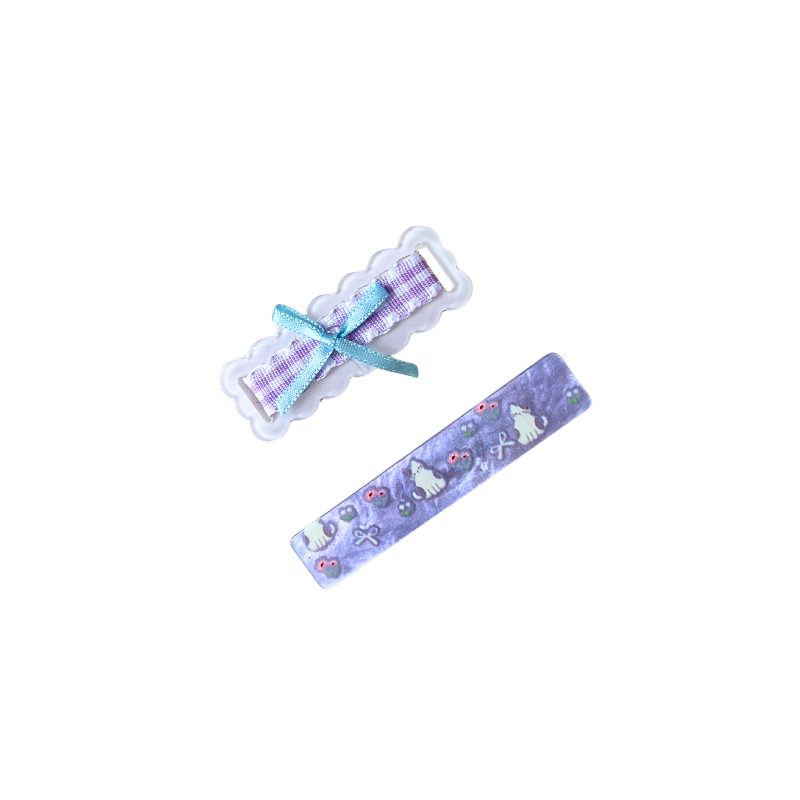 A charming 2‑piece purple hair clip set featuring a scalloped gingham bow clip and a cute kitty‑floral barrette — perfect for soft‑girl, kawaii, and everyday sweet hairstyles.