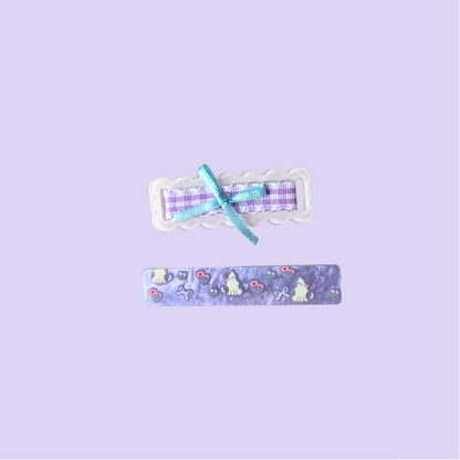A charming 2‑piece purple hair clip set featuring a scalloped gingham bow clip and a cute kitty‑floral barrette — perfect for soft‑girl, kawaii, and everyday sweet hairstyles.
