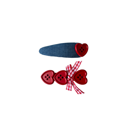 A sweet 2‑piece red heart hair clip set featuring a denim‑style clip with a heart button and a triple‑heart clip with a gingham bow — perfect for soft‑girl, kawaii, and everyday cute hairstyles.