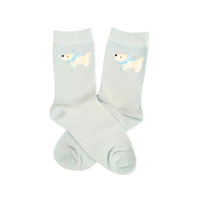 Pair of light blue socks with dog design on a white background