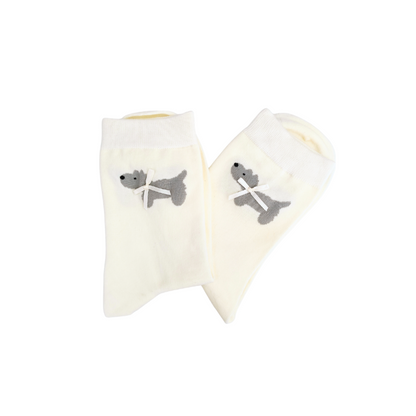 Pair of white socks with gray dog design on a white background