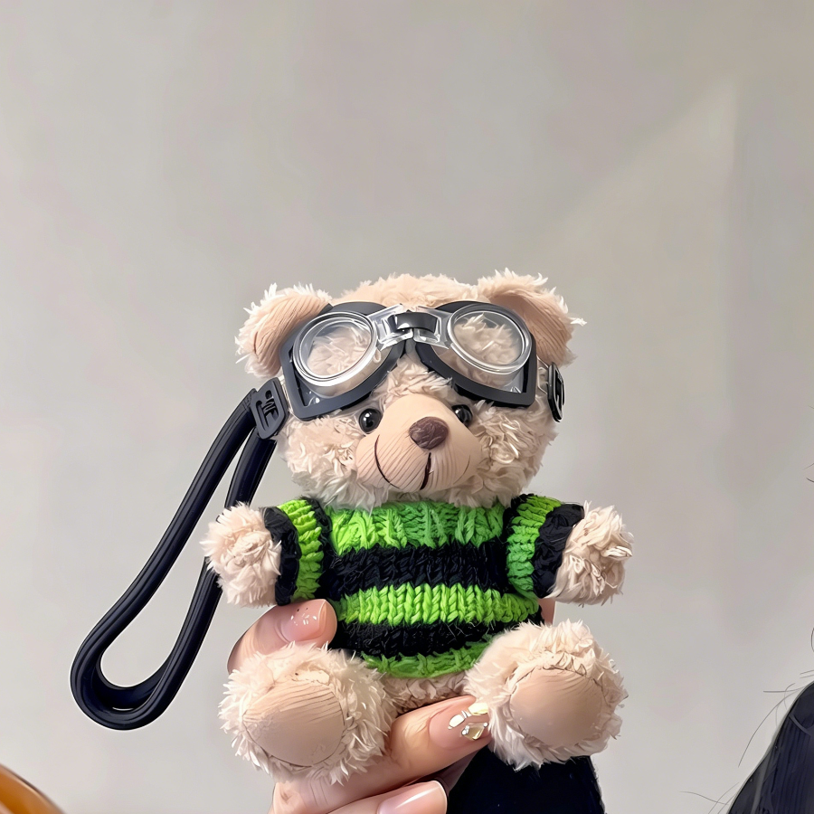 Two plush teddy bear bag charms wearing striped sweaters and goggles, each attached to a clip for bags or keys