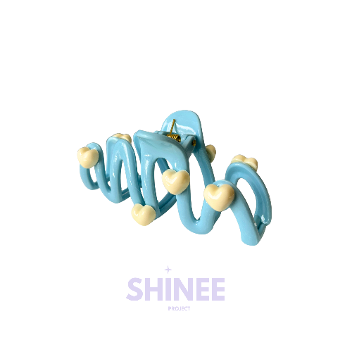 Cute wavy hair clip with cream heart details in a pastel blue colour, sweet and playful hair accessory for girls on a white background
