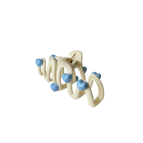 Cute wavy hair clip with blue heart details in a cream colour, sweet and playful hair accessory for girls on a white background