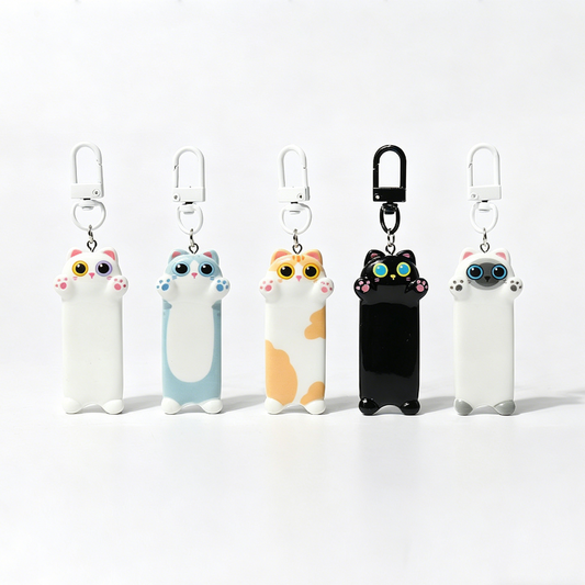 Five cartoon cat keychains on a white background