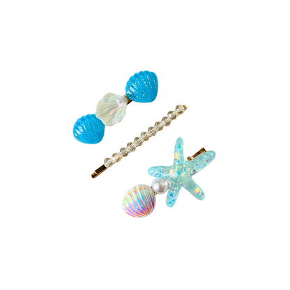 A magical 3‑piece mermaid‑inspired hair clip set featuring shells, pearls, crystals, and a sparkling starfish — perfect for soft‑girl, ocean, and elegant kawaii hairstyles.