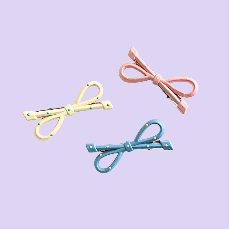 A playful 3‑piece pastel bow hair clip set featuring pink, yellow, and blue polka‑dot bows — perfect for soft‑girl, kawaii, and everyday cute hairstyles.