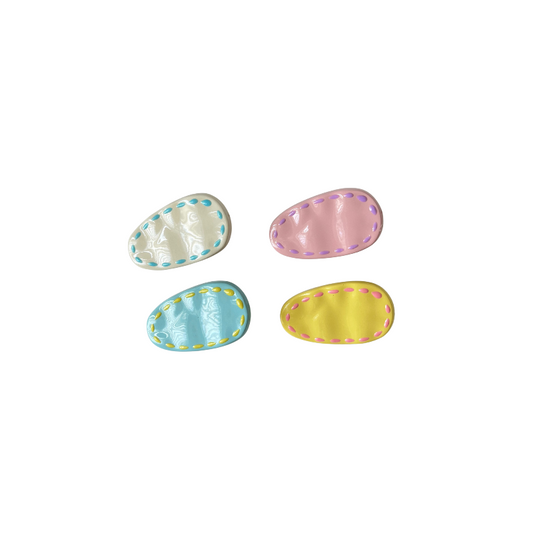 A colourful 4‑piece pastel hair clip set featuring stitched oval designs in cream, pink, blue, and yellow — perfect for soft‑girl, kawaii, and everyday cute hairstyles.