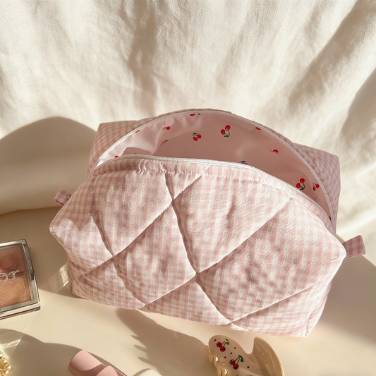 Pink gingham quilted pouch with a pink zipper and cherry‑printed interior lining