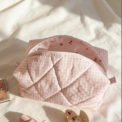 Pink gingham quilted pouch with a pink zipper and cherry‑printed interior lining