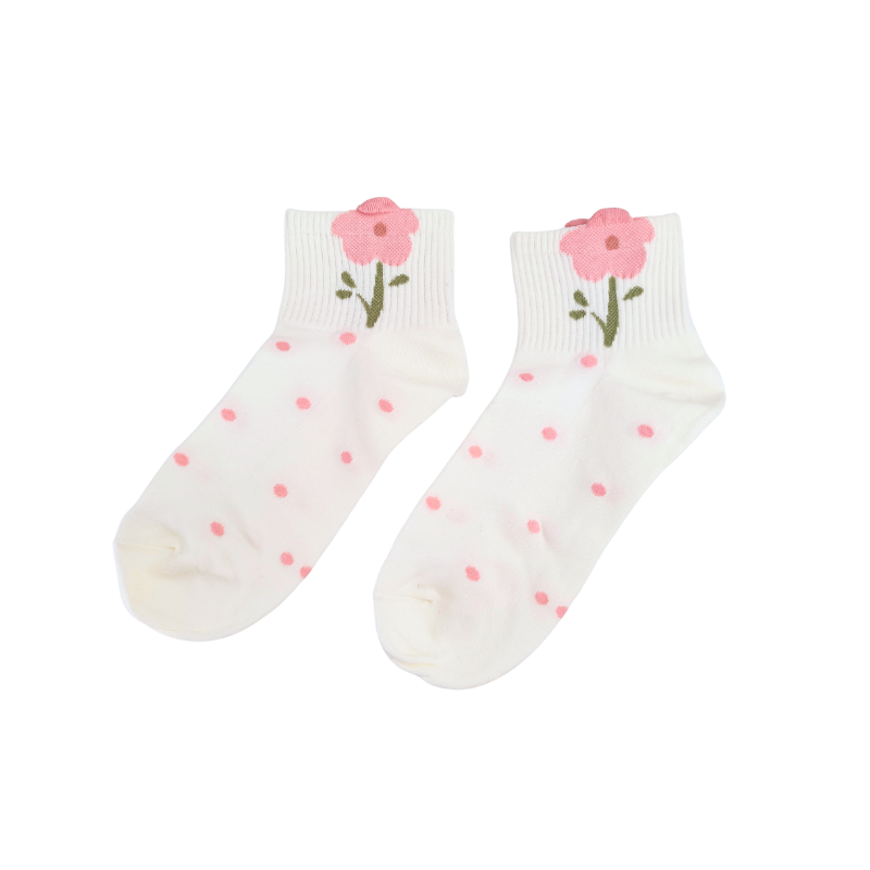 White ankle socks with pink polka dots and a pink flower with a green stem near the cuff