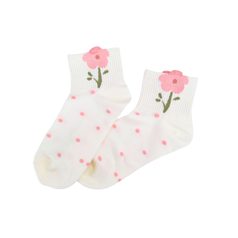 White ankle socks with pink polka dots and a pink flower with a green stem near the cuff