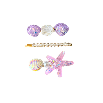 A magical 3‑piece ocean‑themed hair clip set featuring purple shells, crystals, pearls, and a sparkling starfish — perfect for soft‑girl, mermaidcore, and elegant kawaii hairstyles.