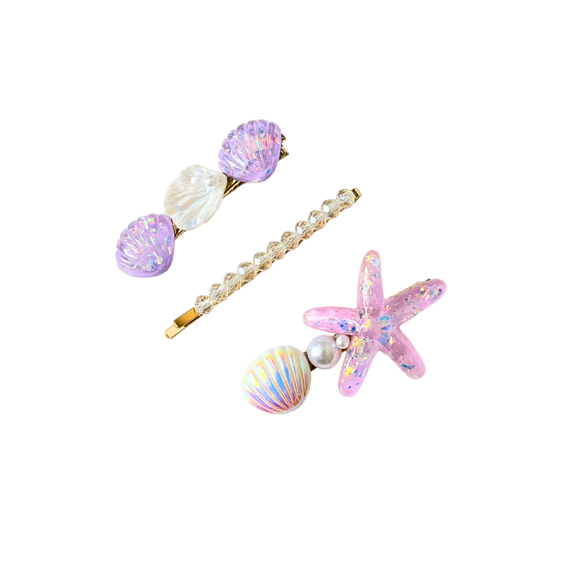 A magical 3‑piece ocean‑themed hair clip set featuring purple shells, crystals, pearls, and a sparkling starfish — perfect for soft‑girl, mermaidcore, and elegant kawaii hairstyles.