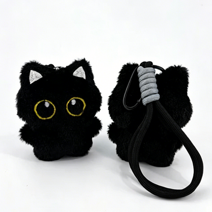 Three black cat plush bag charms with embroidered eyes and striped scarves, each attached to a clip for bags or keys.