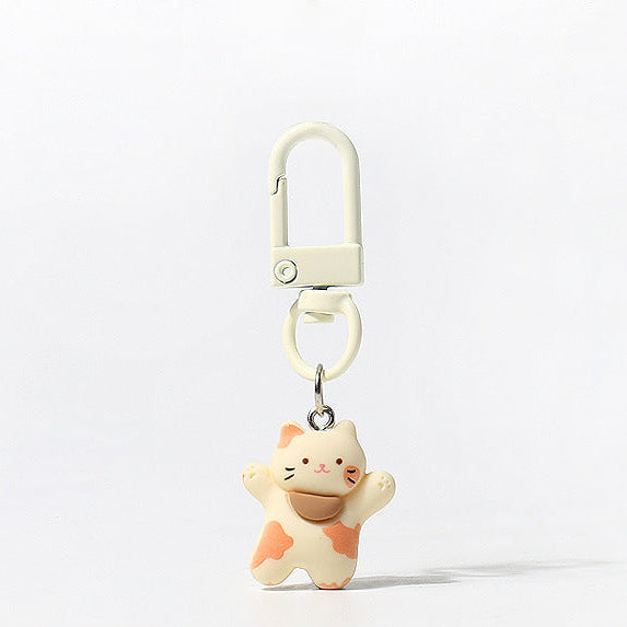 Set of three handmade kitty keychains with raised‑paw designs and matching carabiner clips in brown, white, and tri‑colour styles