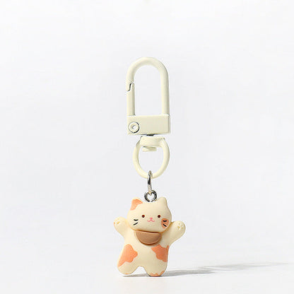Set of three handmade kitty keychains with raised‑paw designs and matching carabiner clips in brown, white, and tri‑colour styles
