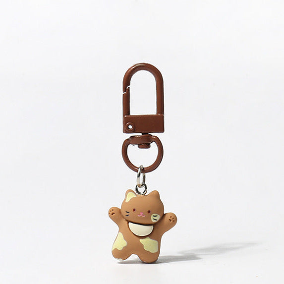 Set of three handmade kitty keychains with raised‑paw designs and matching carabiner clips in brown, white, and tri‑colour styles